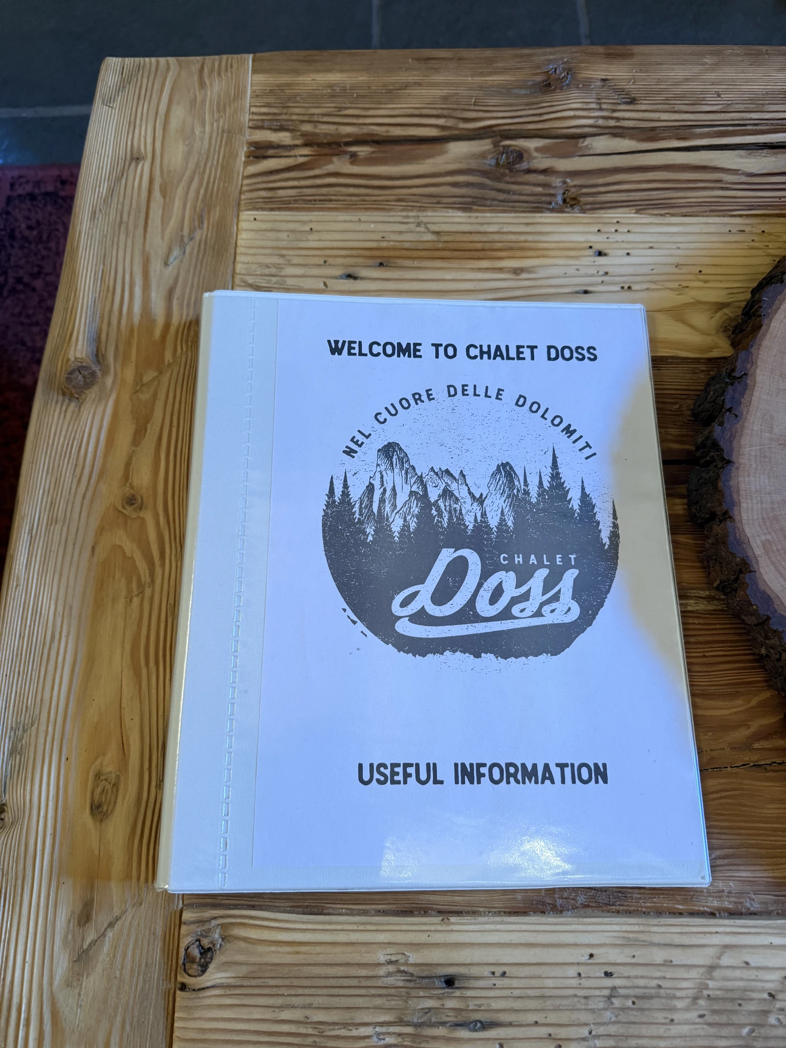 Welcome to Chalet Doss information book resting on a wooden table
