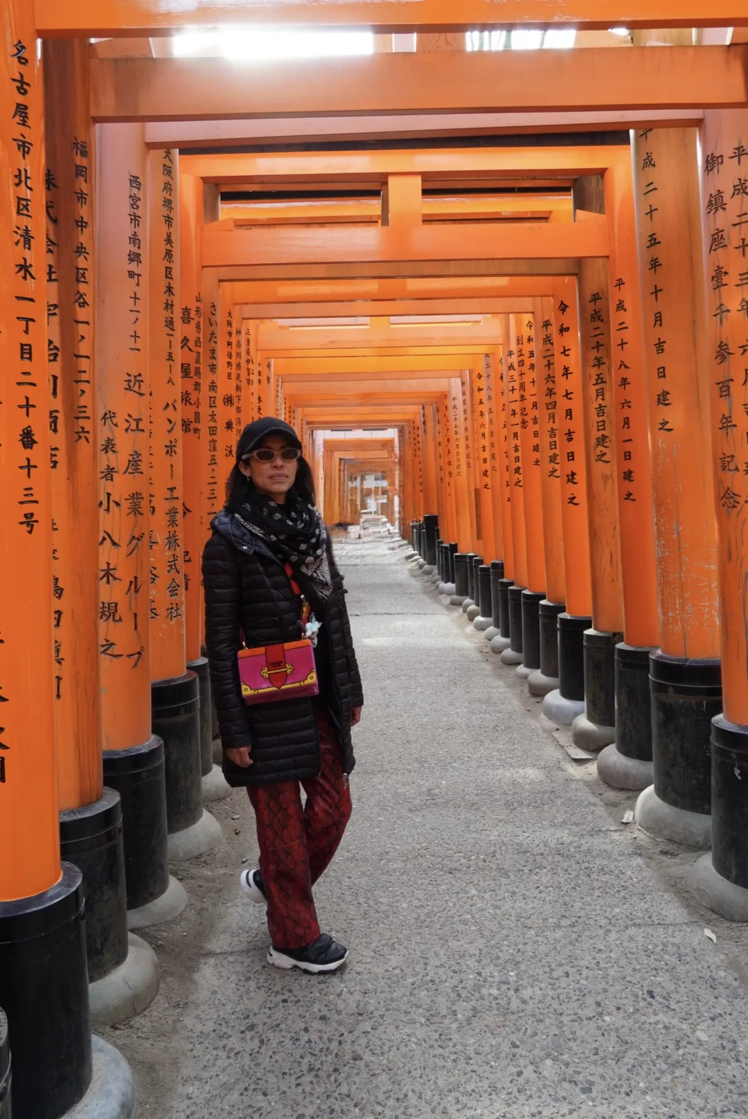 Walking beneath the vermilion torii gates at Fushimi Inari in Kyoto